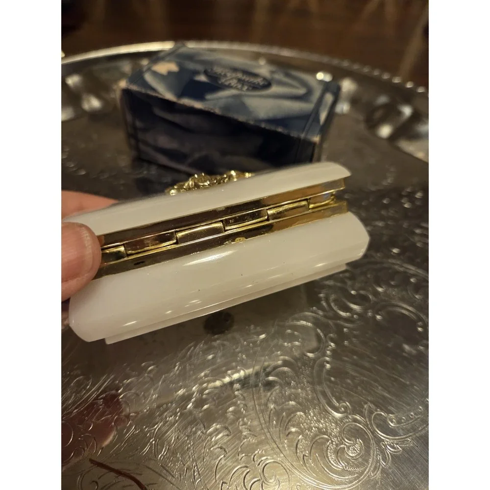 vintage white hinged trinket box features a polished finish with a delicate,...